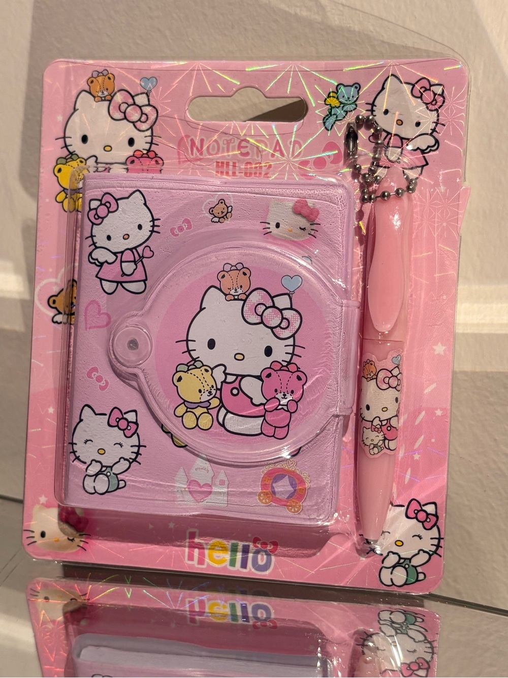 Hello kitty mini pink notebook with pen keychain.